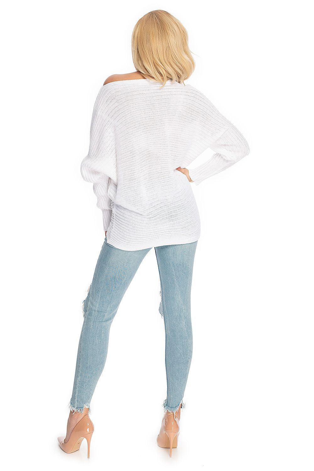 Woman in white loose kimono-style pullover with ribbed hem, model 146916 PeeKaBoo, paired with light blue jeans and heels