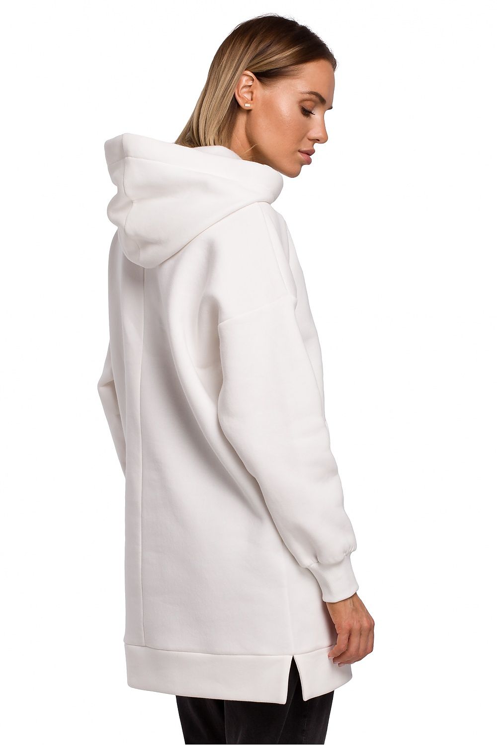 Model wearing white oversized hooded pullover, side view, perfect for cold days, can be styled as dress, casual cotton blend look.