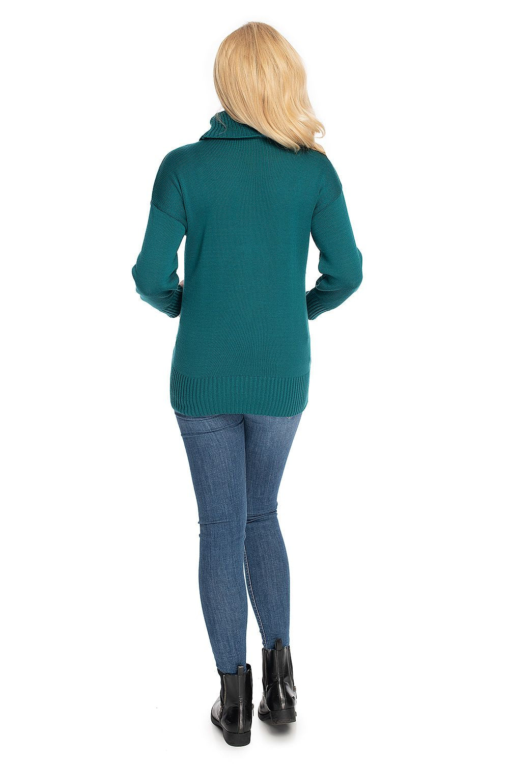 Back view of woman in teal maternity turtleneck, long sleeves, paired with jeans and boots. Classic, comfy fashion statement.