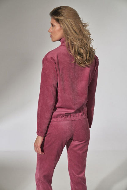 Model wearing pink corduroy blouse with collar and decorative zipper, long sleeves and elasticated hem. Back view detail.