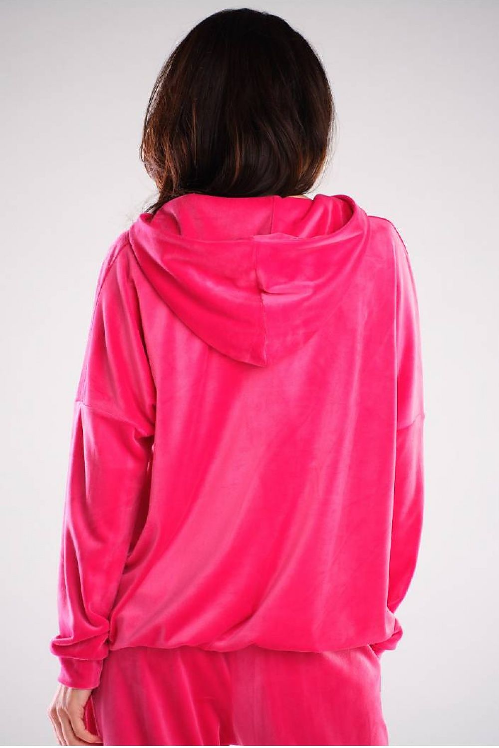 Back view of a pink velvet hoodie with relaxed fit, large pocket, and hood, designed for urban style. Features polyester and spandex blend.