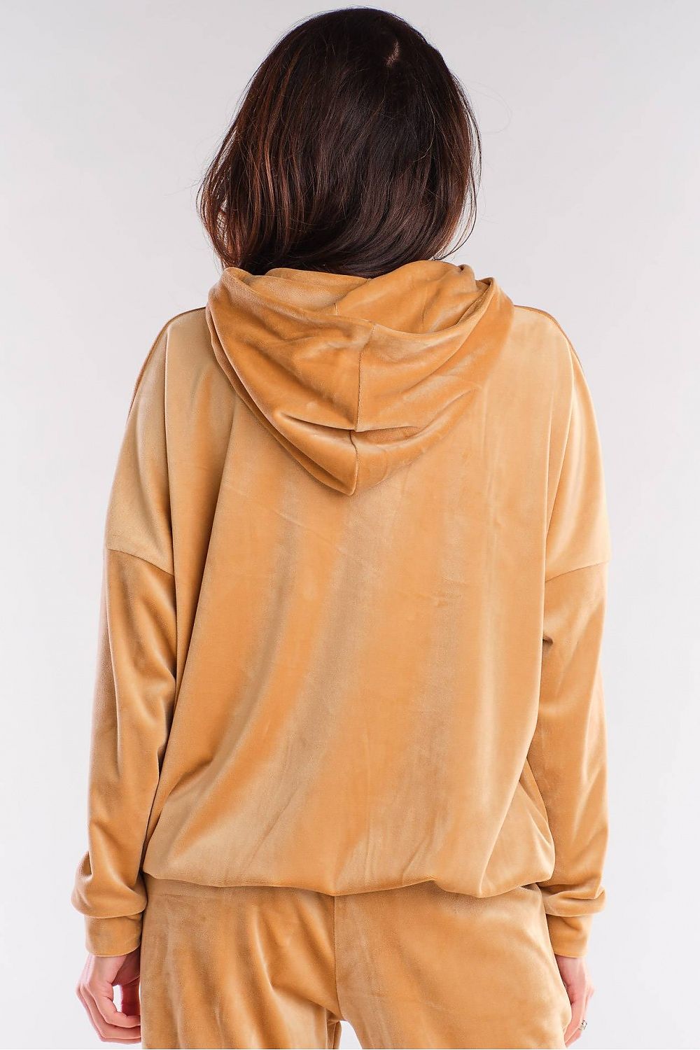 Back view of a tan velvet hoodie with functional pockets and a hood, showcasing a trendy urban style. Designed and made in Poland.