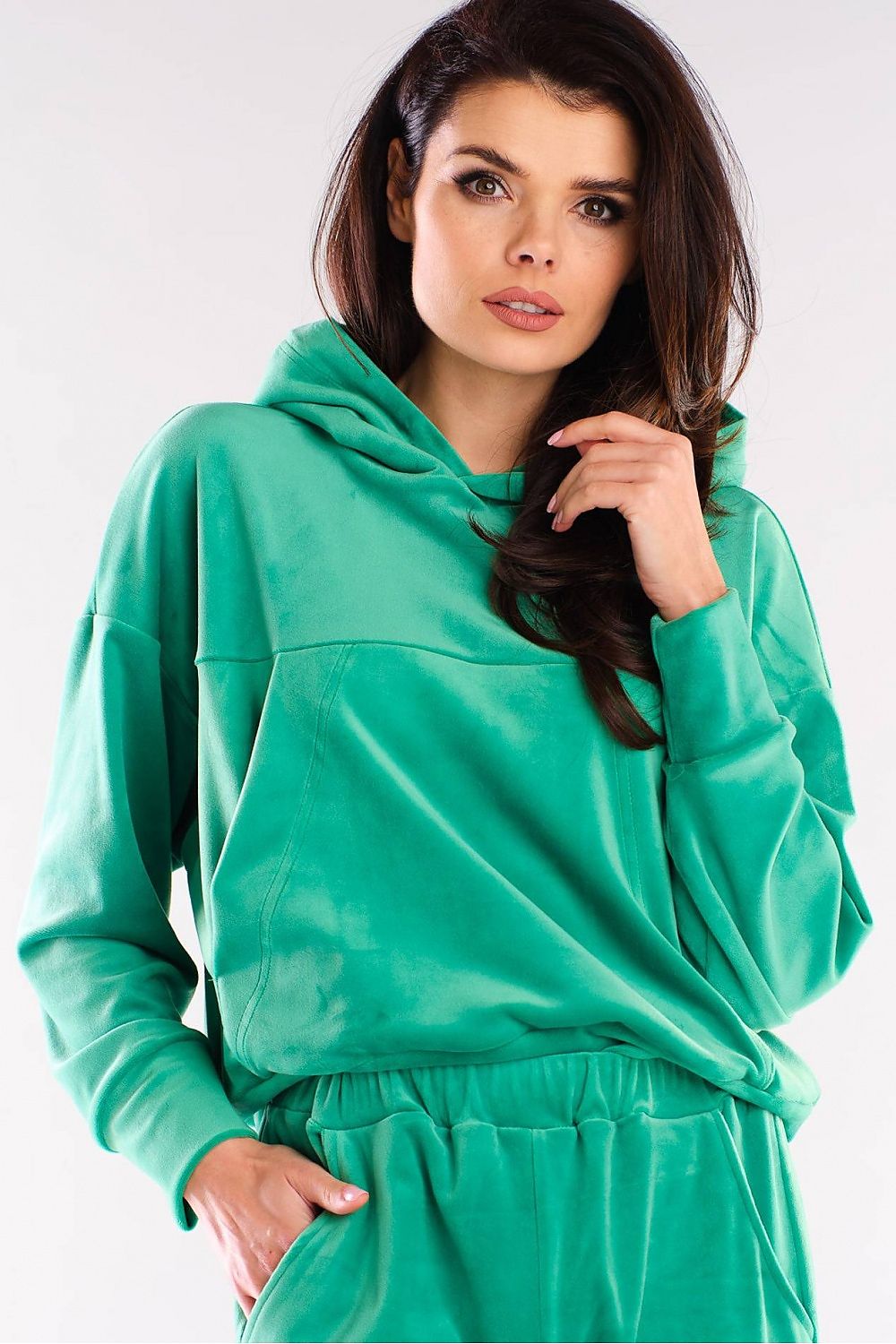 Model in green velour hoodie, Szabadidőfelső model 155464 awama, perfect with jeans or sneakers, designed in Poland.