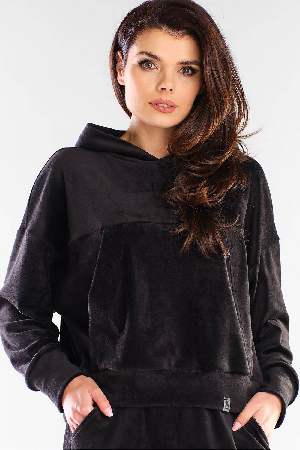 Model wearing black hooded velvet pullover with kangaroo pocket by awama, showcasing a casual and versatile design.