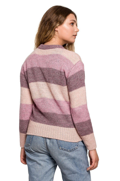 Model wearing Pulóver model 157606 BE Knit in pink and beige stripes, showcasing back view. Perfect for autumn and winter comfort.