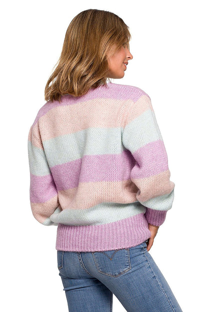 Woman wearing colorful striped knit pullover, perfect for fall and winter fashion.