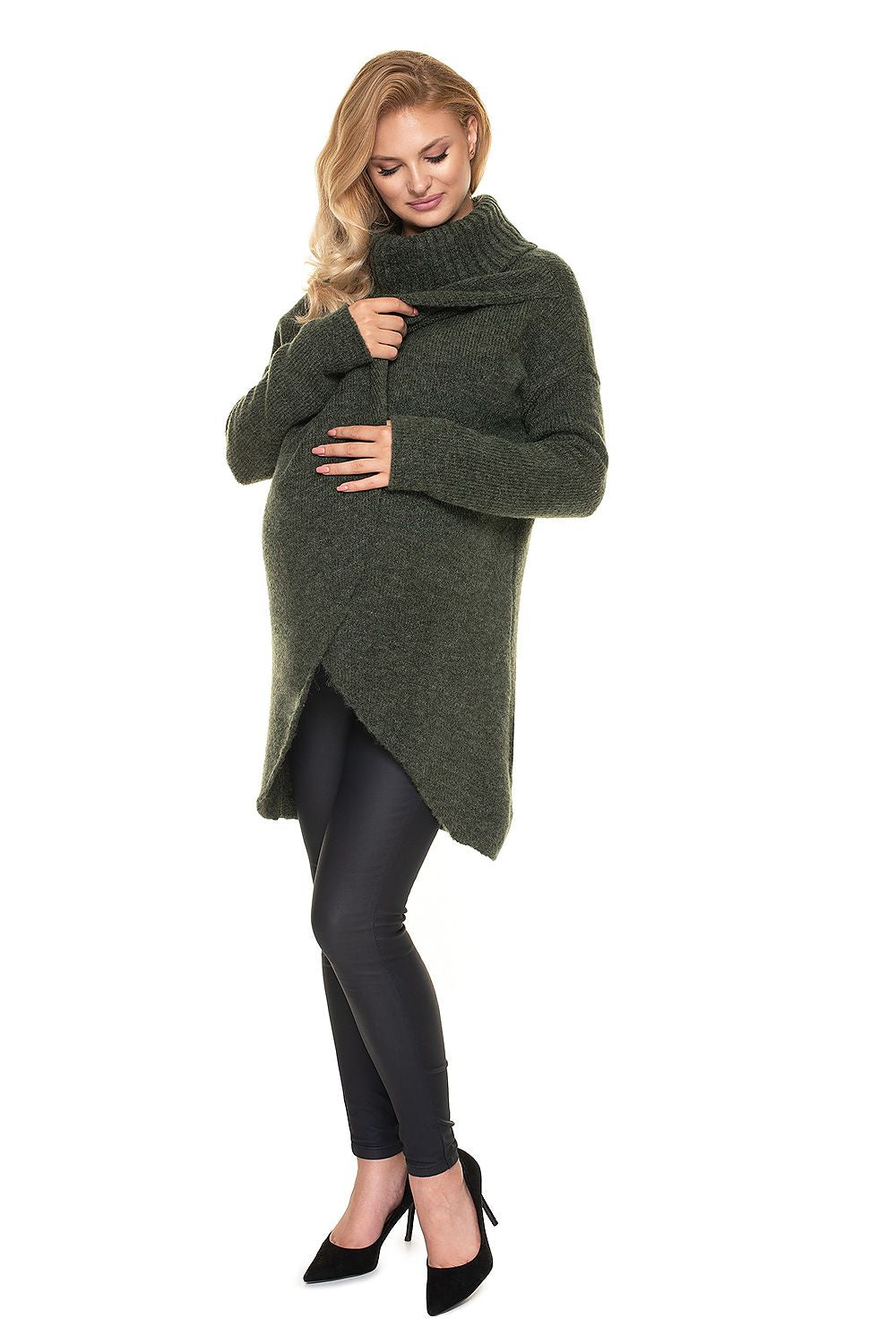 Model wearing green asymmetrical maternity pullover with loose turtleneck, perfect for pregnancy and nursing. Comfy and stylish.