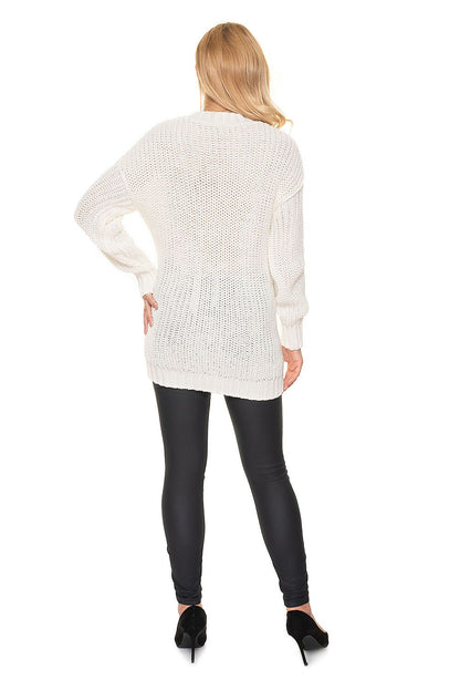 Back view of a long white maternity sweater with stand-up collar and braided design, worn by a model in leggings. 100% acrylic.