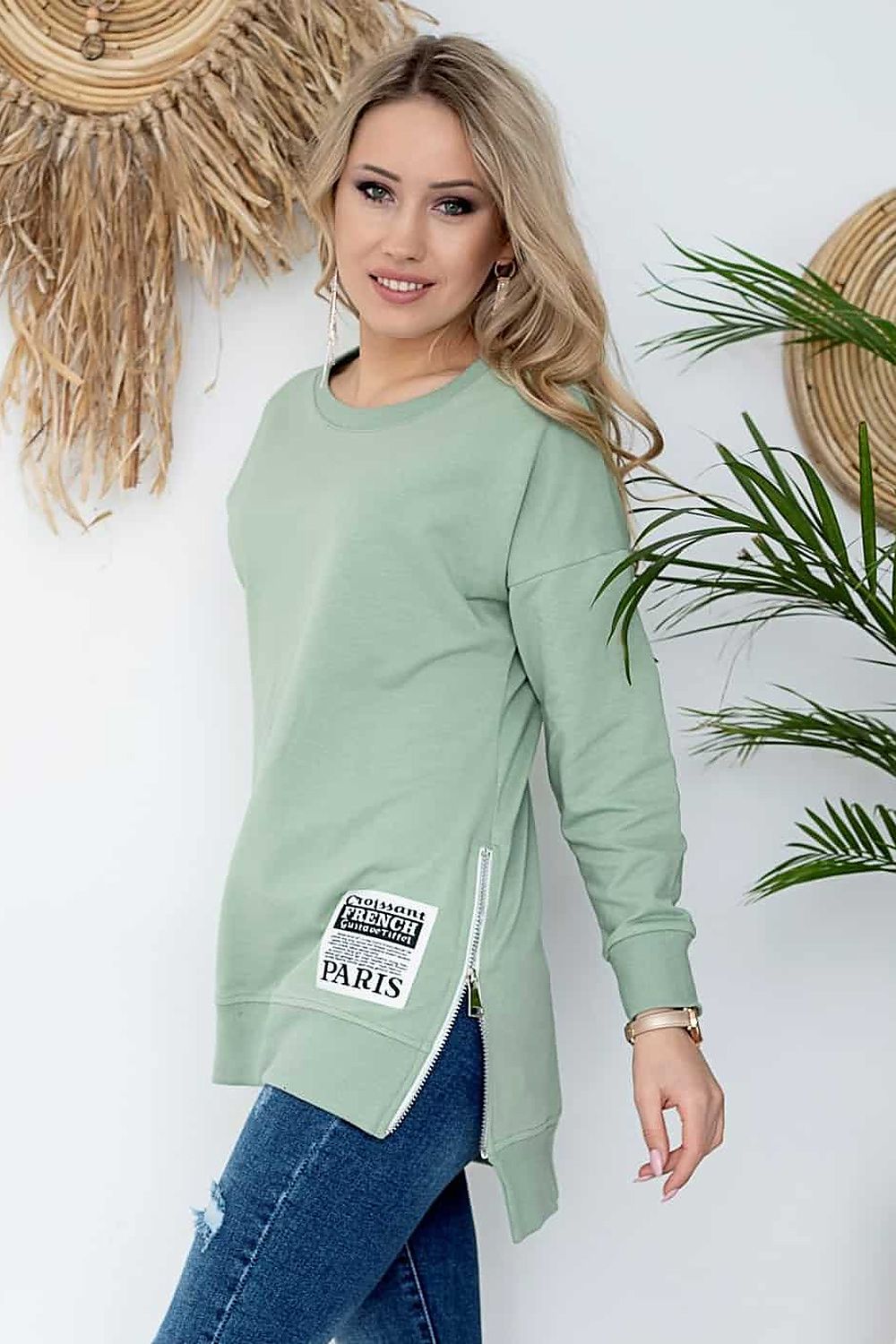 Woman wearing Szabadidőfelső model 158257, a stylish green cotton pullover with side zippers and patches, perfect for casual wear.