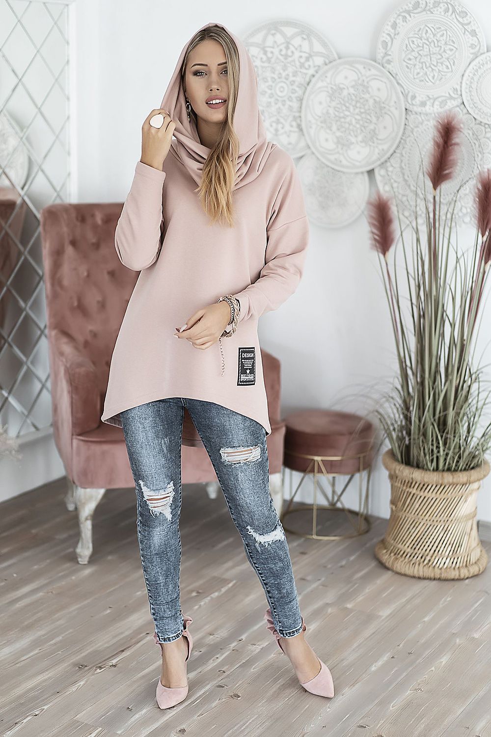 Casual pink hoodie with convertible cowl neck worn by a model in stylish ripped jeans and pink heels, perfect for chic outings.