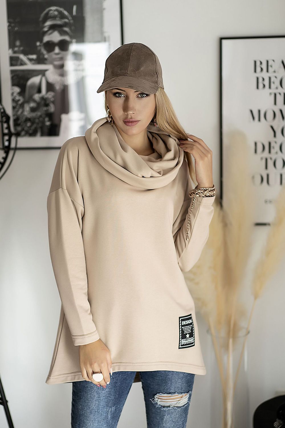 Stylish woman in beige oversized hoodie with cowl neck, ideal for casual wear, blends fashion and comfort seamlessly.