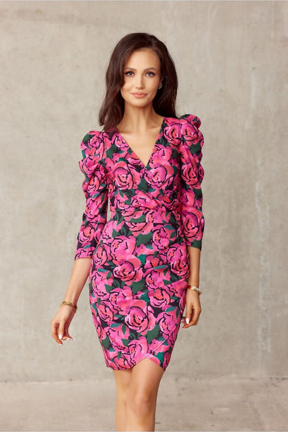 Woman in a floral, knee-length dress with puffed shoulders, enhancing a slim silhouette, by Roco Fashion.