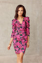 Woman in a floral, knee-length dress with puffed shoulders, enhancing a slim silhouette, by Roco Fashion.