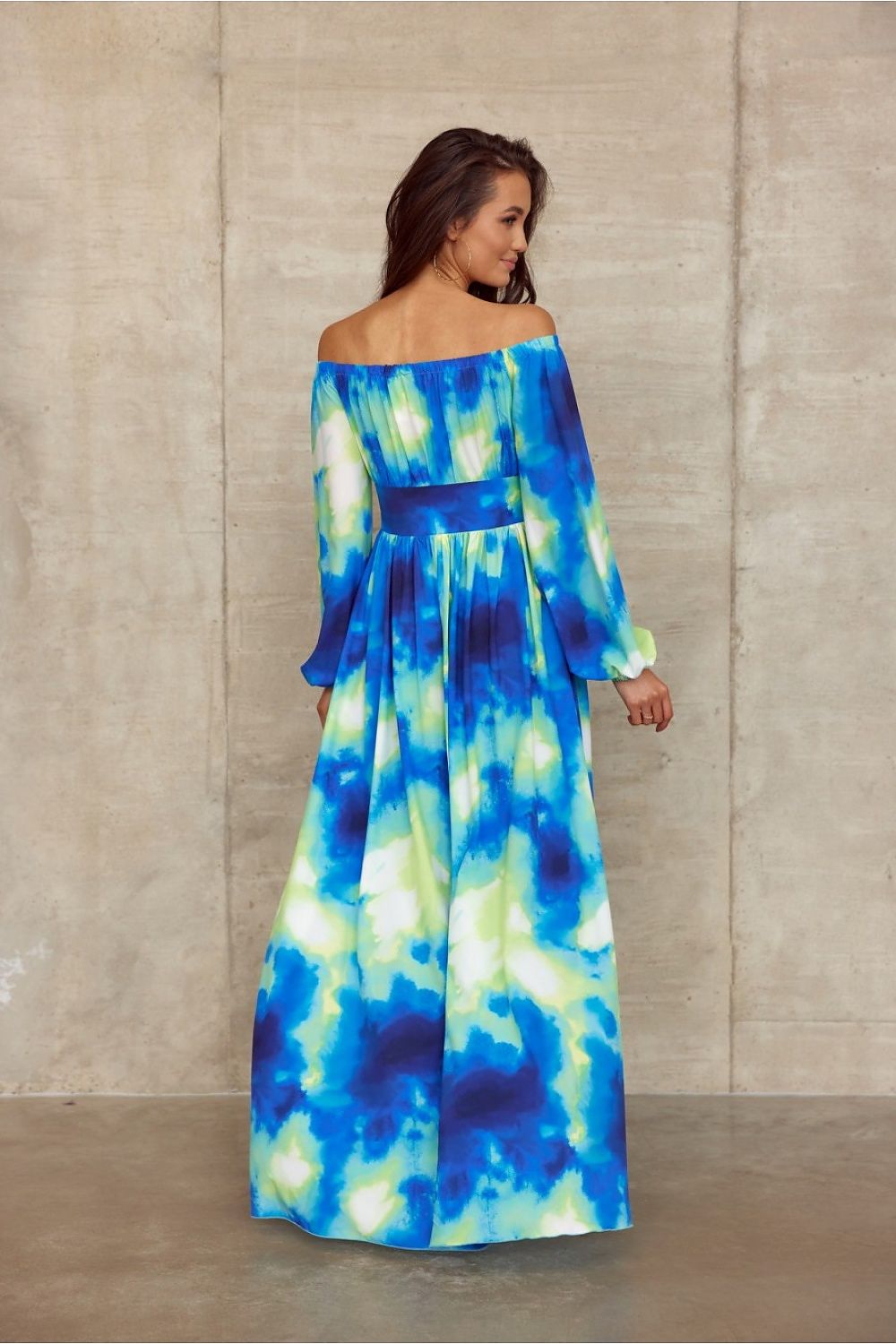 Vibrant blue-green off-shoulder maxi dress with waist tie, open back, and airy sleeves, perfect for an elegant summer look.